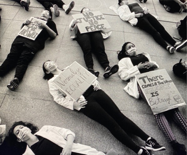 photo of people lying on the sidewalk