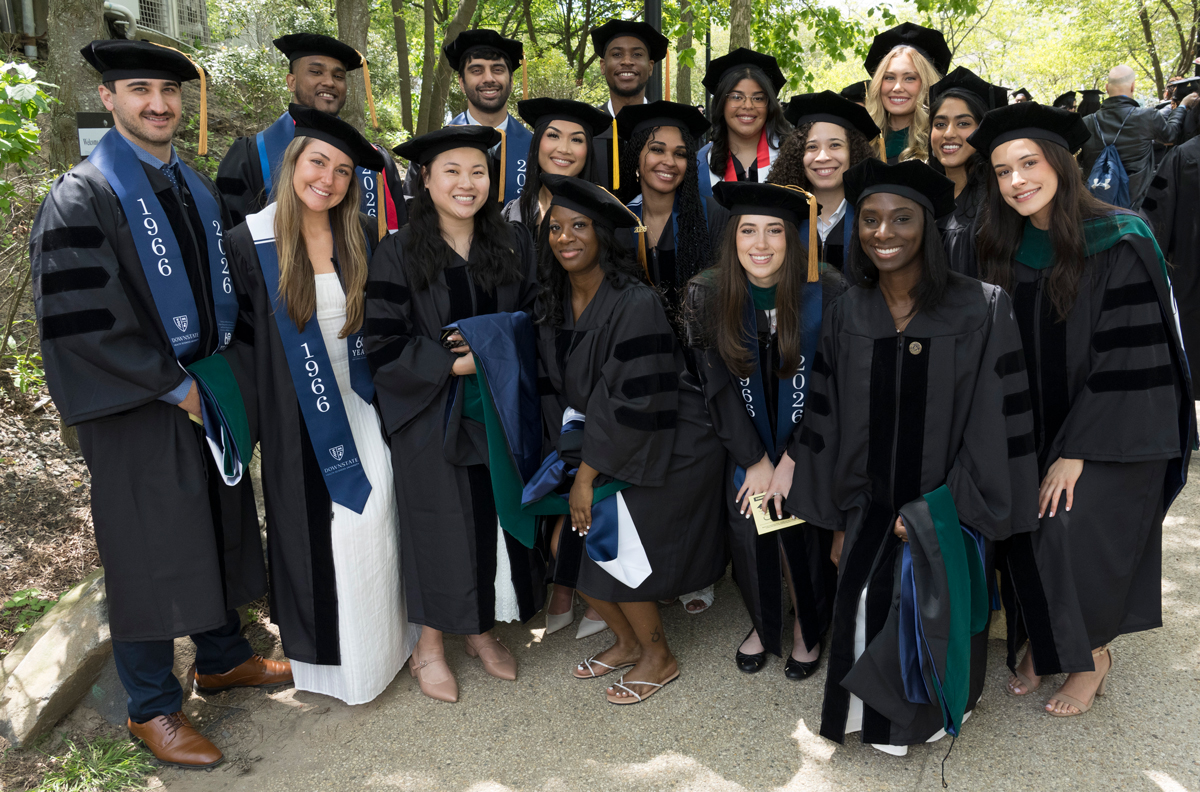 photo of smiling grads standing together outside