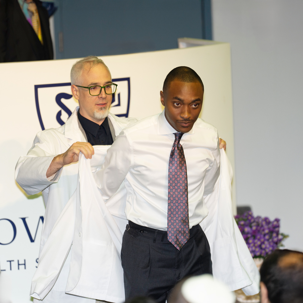 student at a white coat ceremony