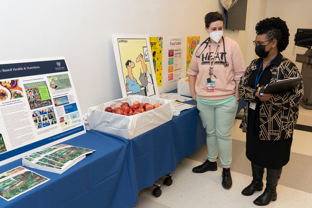 two people standing by a table