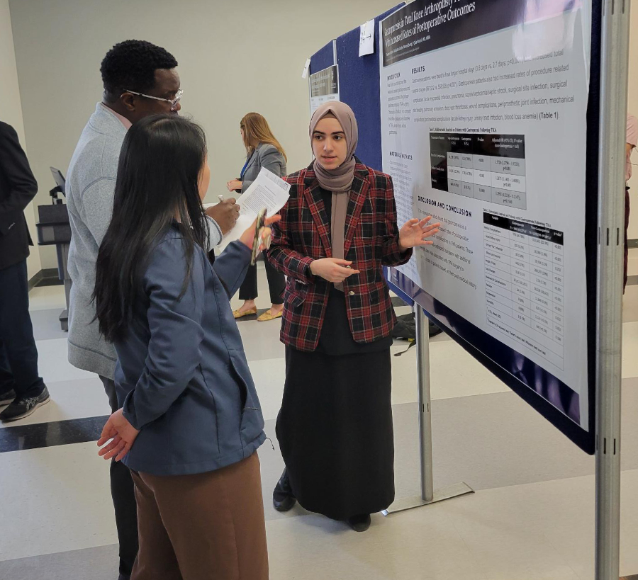 student in front of poster