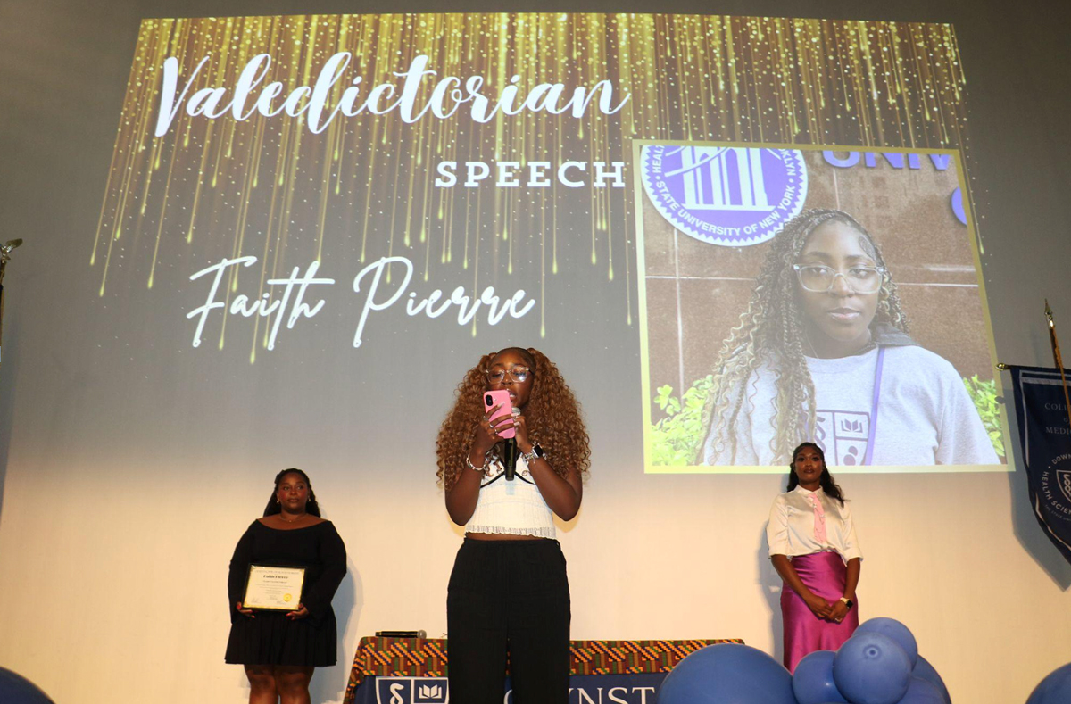 photo of young woman speaking on a stage
