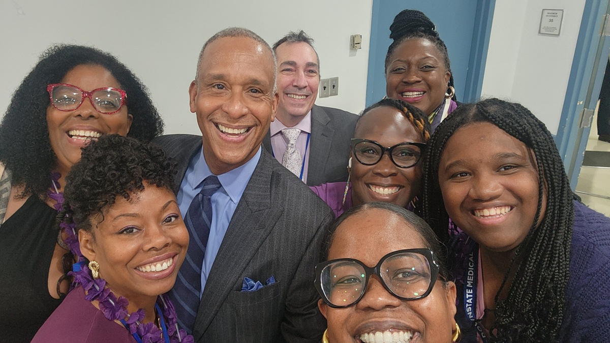 selfie photo of Dr Riley and 7 other people all smiling