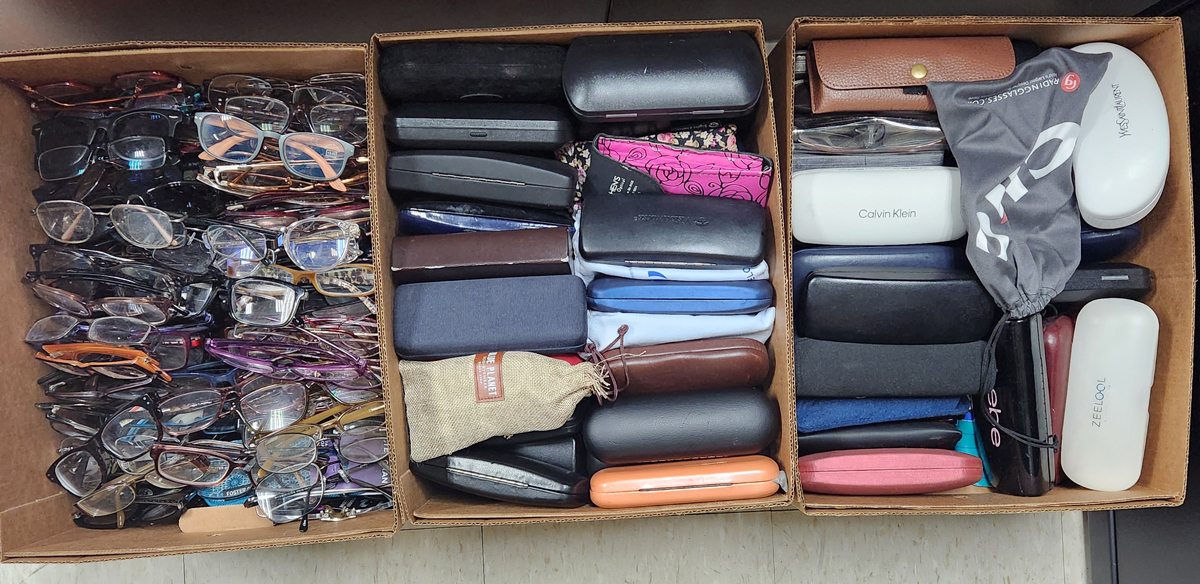 photo of boxes filled with eyeglass frames and cases