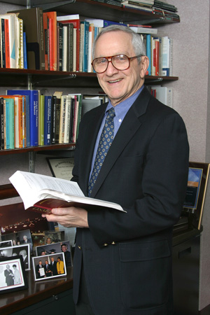 photo of Dr Feigelson holding a book