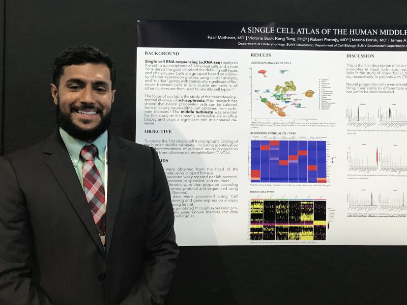 man standing in front of poster