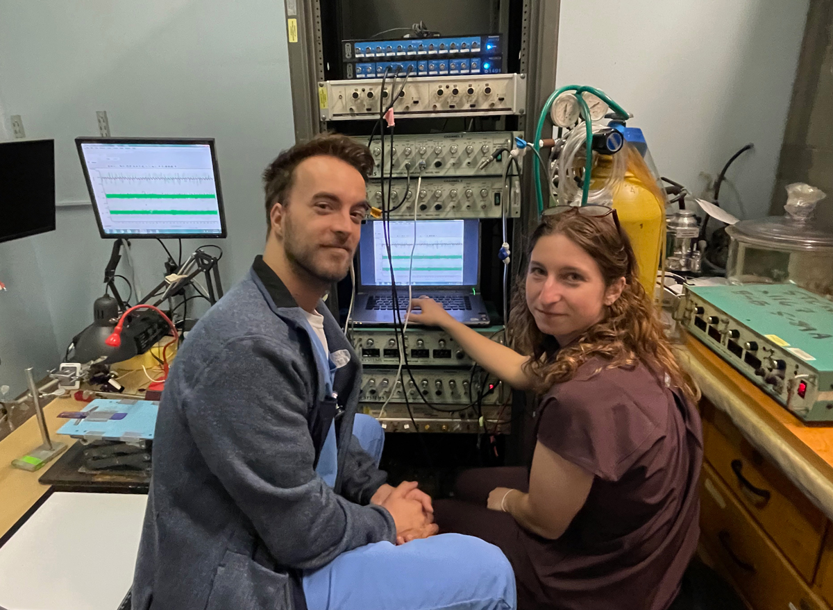 photo of two people in front of computer