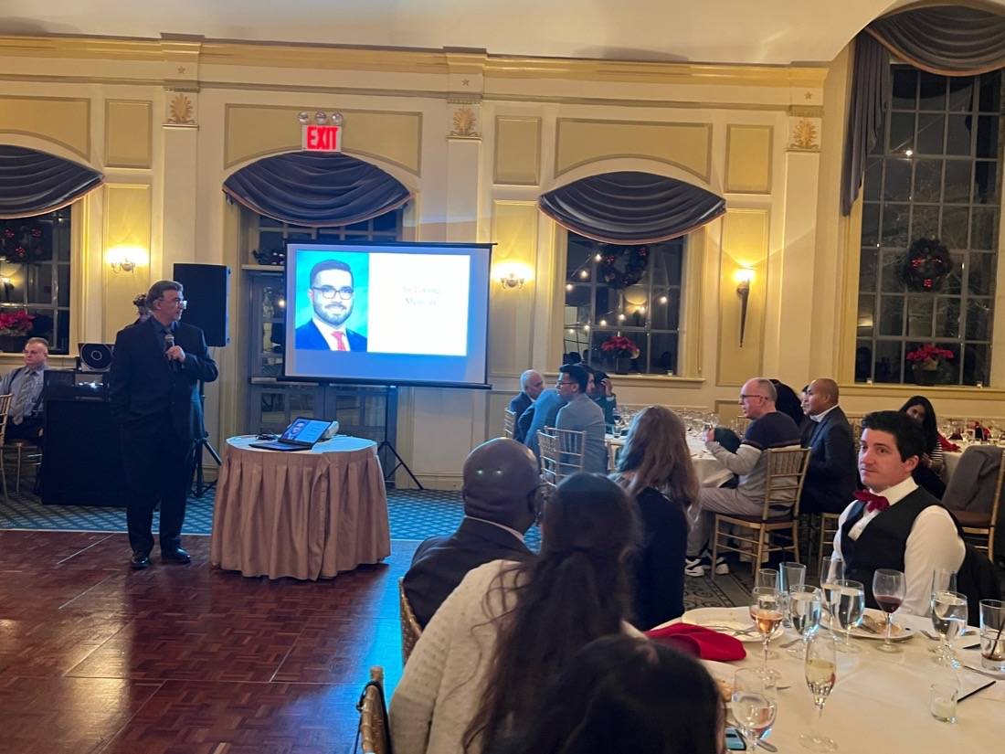 Dr. Kougias presenting Erfan tribute at Holiday dinner 2023