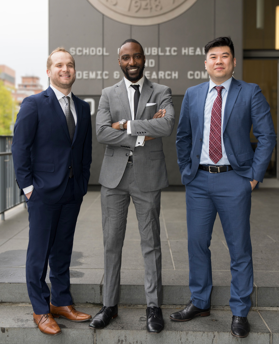 photo of three men standing on steps outside of SUNY Downstate School of Health building
