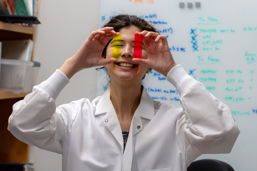 photo of justine lottermoser holding fluorescent slides