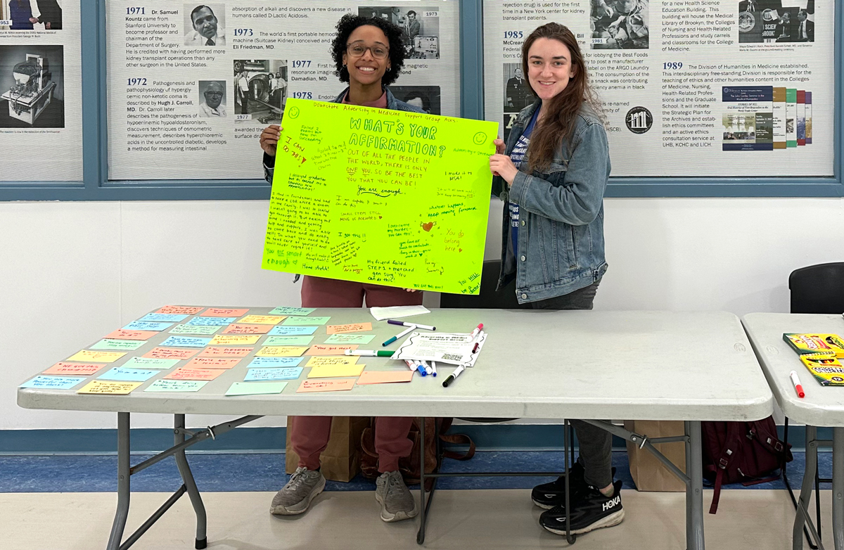 two students with a poster