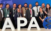 Group Photo behind APA Logo