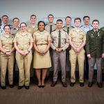 Sierrah Grigsby in a group photo with other individuals in military dress