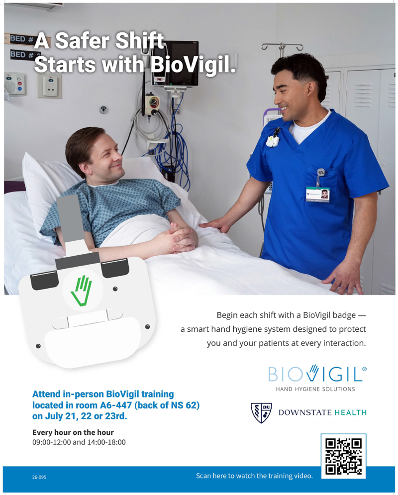 a male doctor, smiling, standing next to a hospital bed with a smiling man looking back