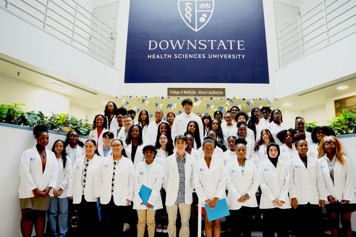 group of young students standing on steps