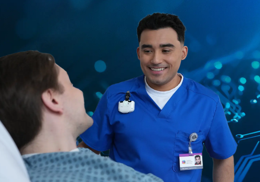 photo of man in hospital bed talking with other man