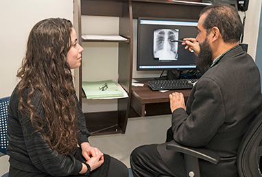 photo of doctor with patient and xray