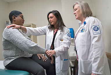 photo of 2 doctors examining patient