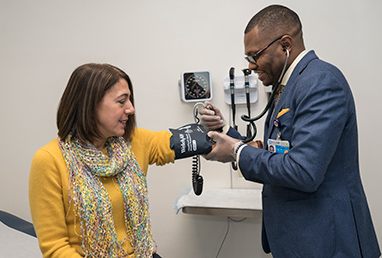 photo of doctor checking blood pressure