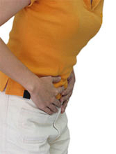 person holding stomach in pain