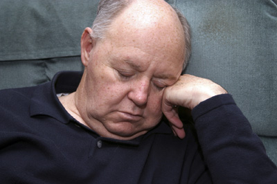 photo of man asleep in chair