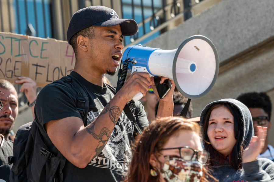 photo of young man with bullhorn